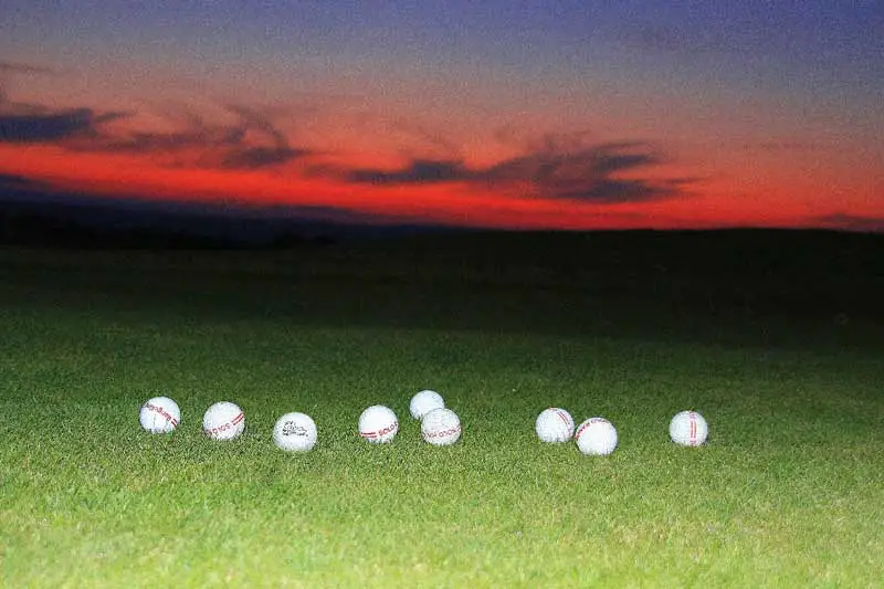 Used golf balls on the grass